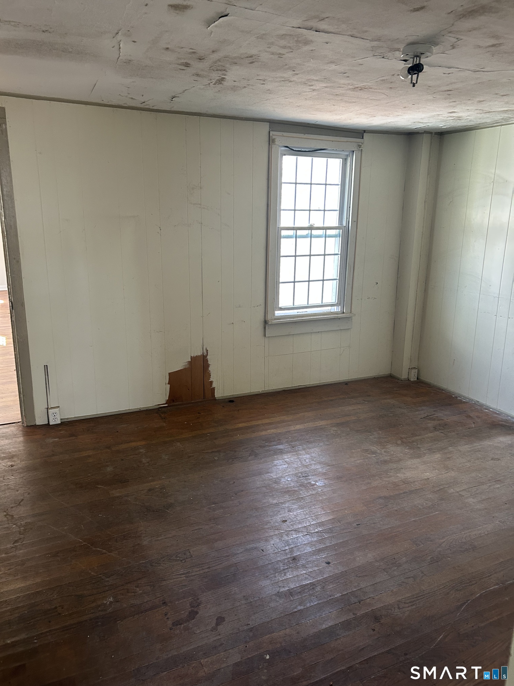 134 Sillimanville Road East Haddam, CT 06469 - Photo 12 of 27 an empty room with wooden floor and windows
