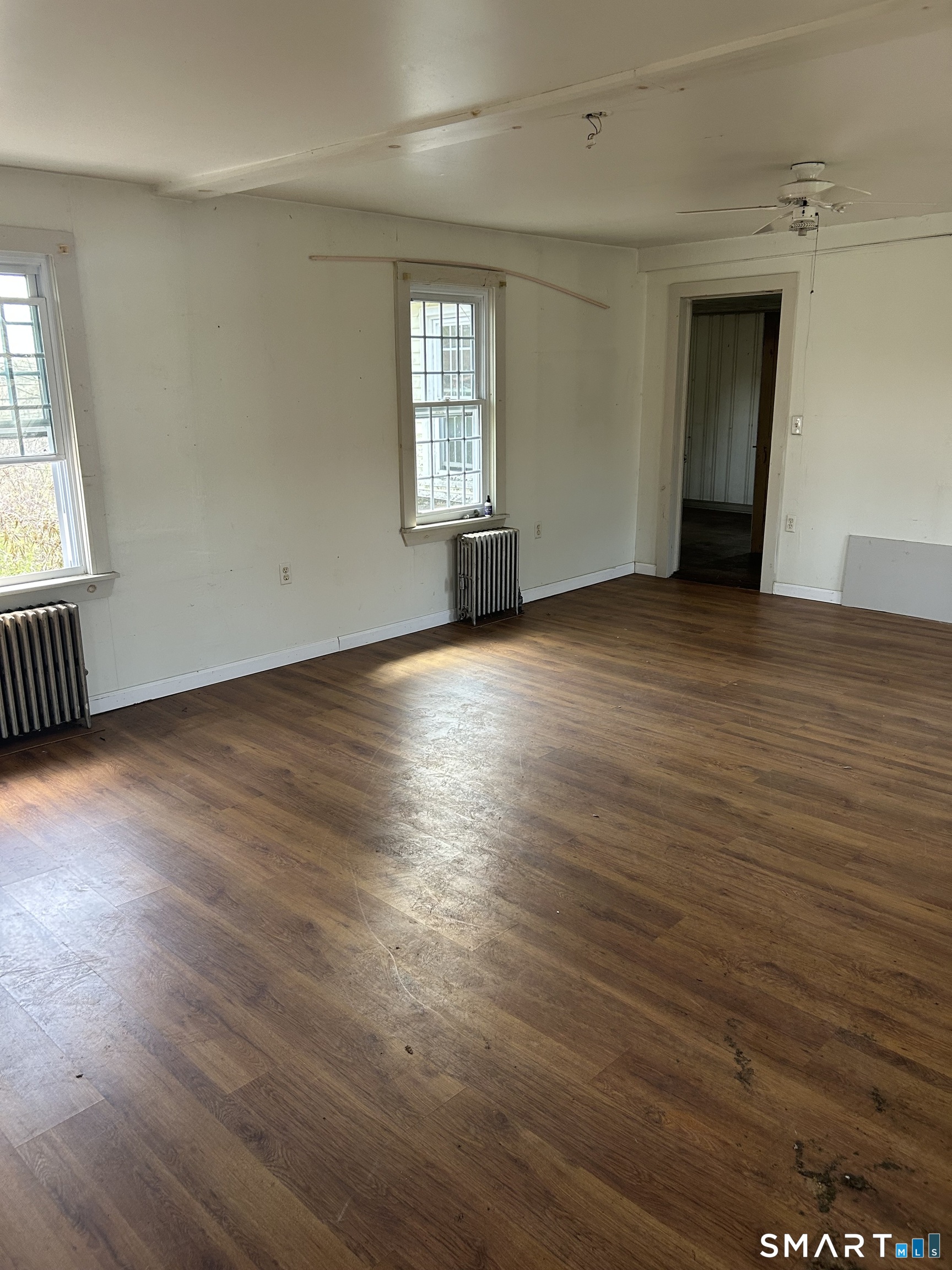 134 Sillimanville Road East Haddam, CT 06469 - Photo 13 of 27 an empty room with wooden floor and windows