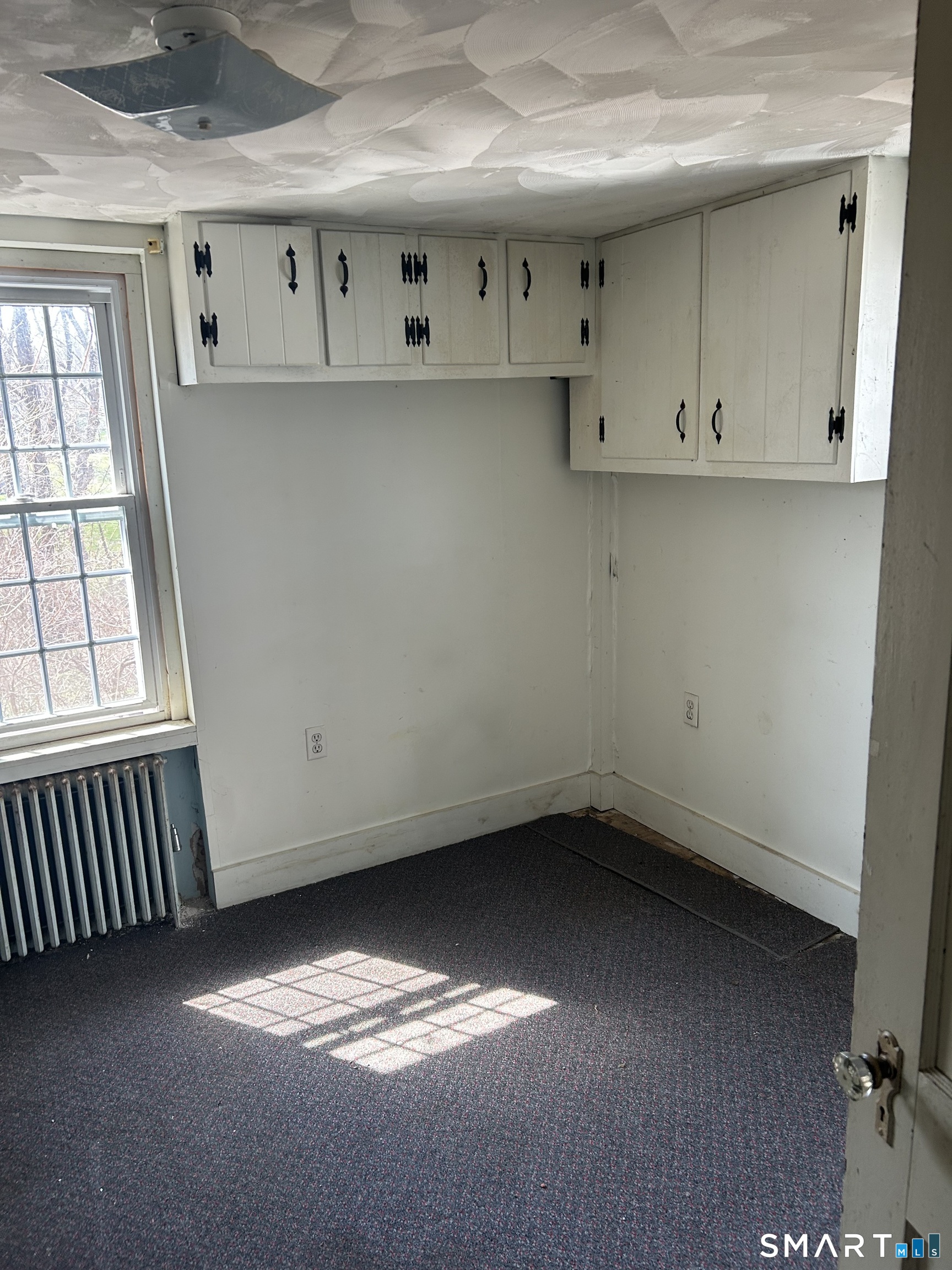 134 Sillimanville Road East Haddam, CT 06469 - Photo 18 of 27 an empty room with a fireplace and windows