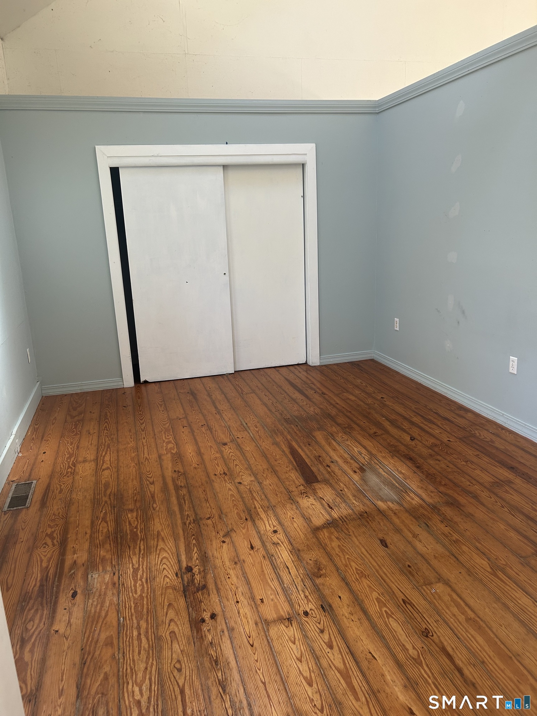 134 Sillimanville Road East Haddam, CT 06469 - Photo 26 of 27 a view of an empty room with wooden floor and a window