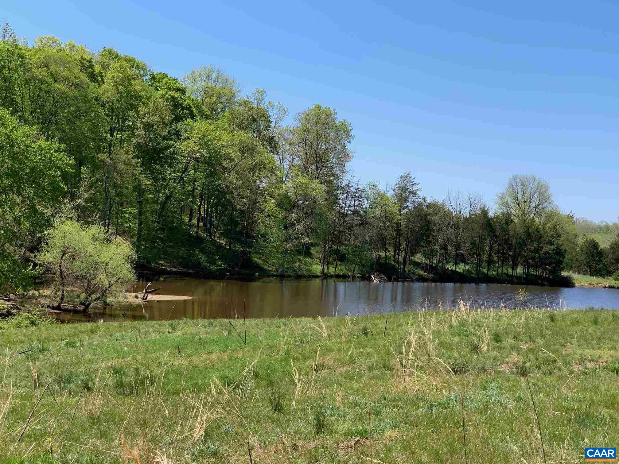 Parcel #1 Parcel Road Rochelle, VA 22738 - Photo 14 of 25 a view of a lake with a house in the background