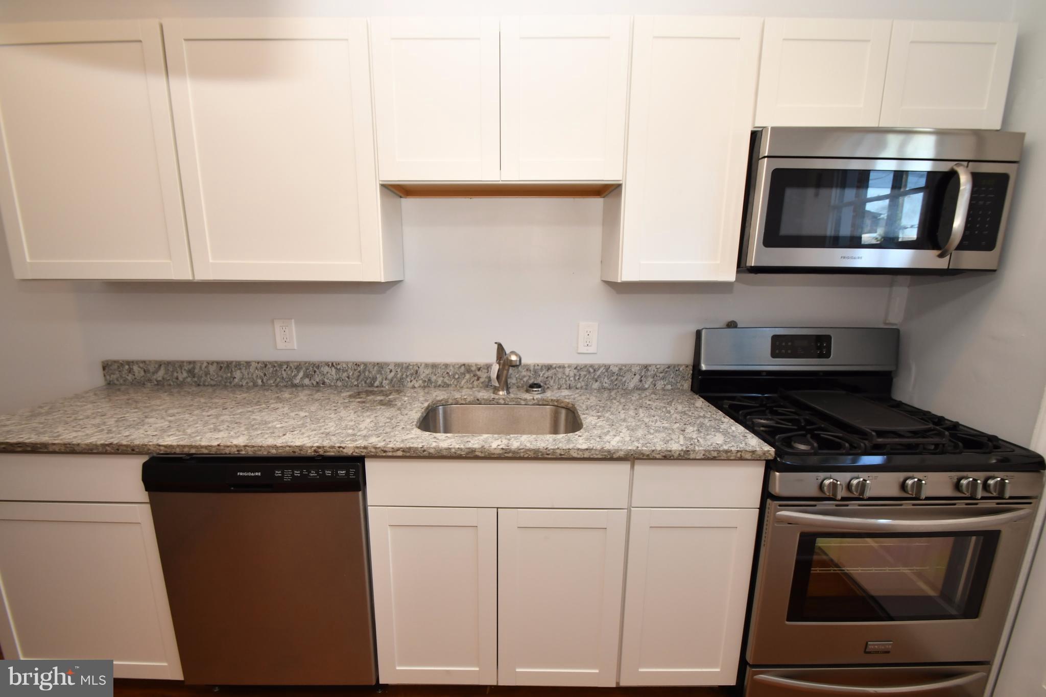 3520 Dunhaven Road Baltimore, MD 21222 - Photo 11 of 30 a kitchen with stainless steel appliances granite countertop a sink stove and microwave