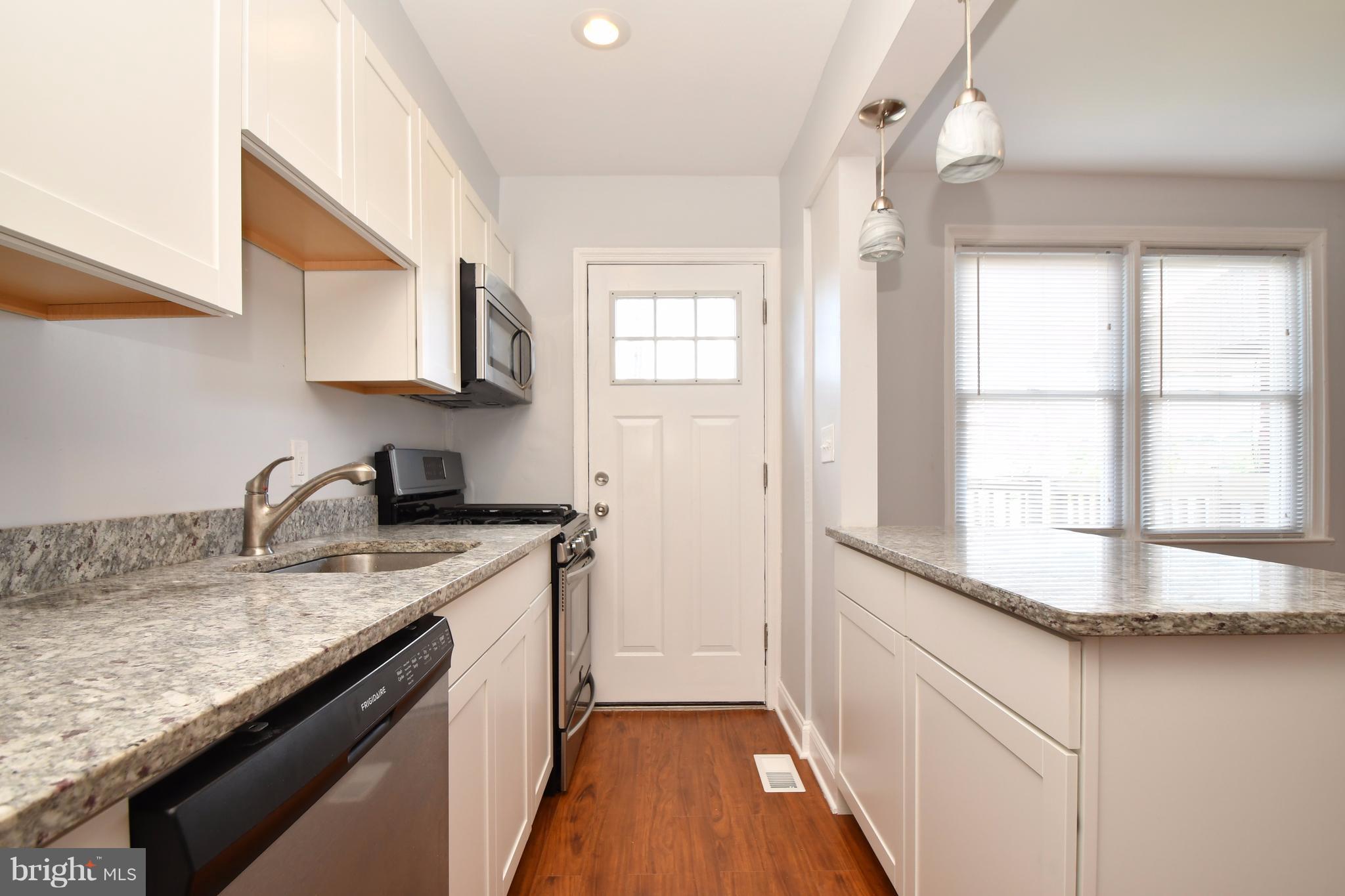 3520 Dunhaven Road Baltimore, MD 21222 - Photo 13 of 30 a kitchen with granite countertop stainless steel appliances a sink window and cabinets