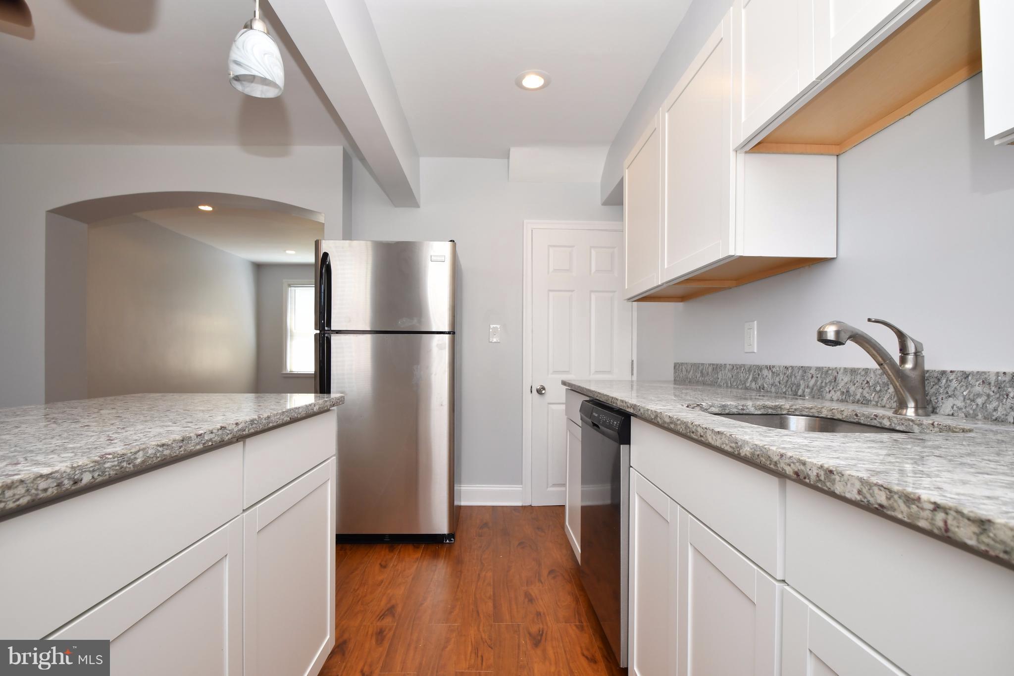 3520 Dunhaven Road Baltimore, MD 21222 - Photo 14 of 30 a kitchen with stainless steel appliances granite countertop a sink a refrigerator and a granite counter tops