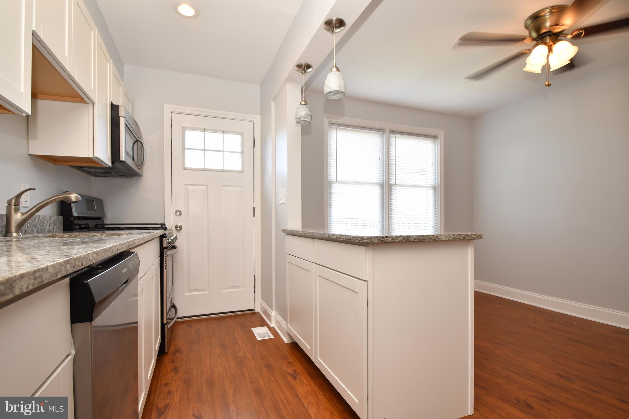 3520 Dunhaven Road Baltimore, MD 21222 - Photo 15 of 30 a kitchen with granite countertop a sink cabinets stainless steel appliances and a window