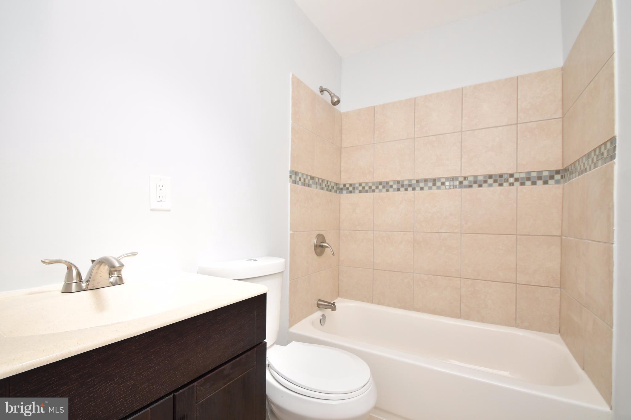 3520 Dunhaven Road Baltimore, MD 21222 - Photo 20 of 30 a bathroom with a bathtub shower sink vanity and toilet