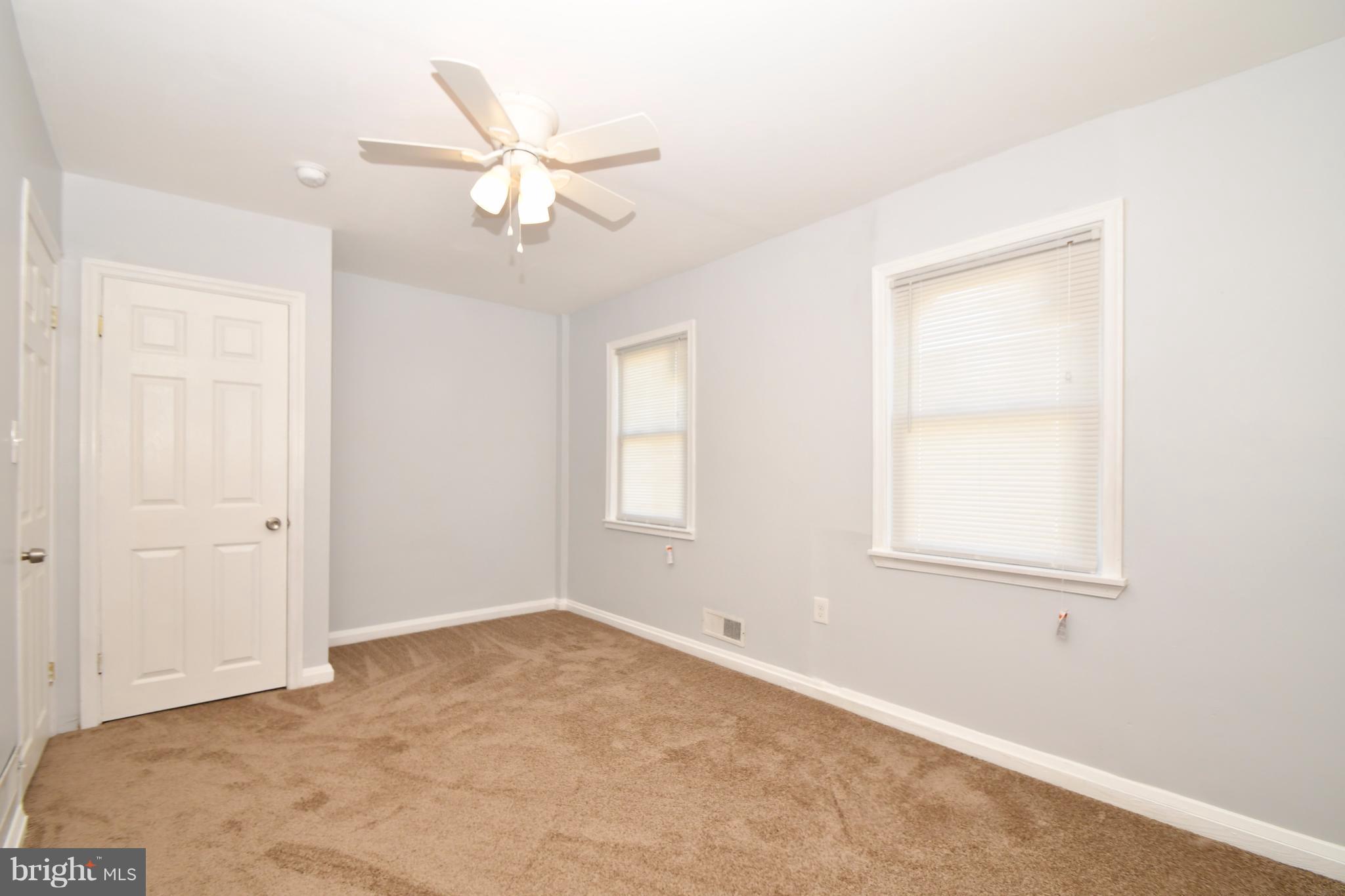 3520 Dunhaven Road Baltimore, MD 21222 - Photo 22 of 30 an empty room with a window and a fan