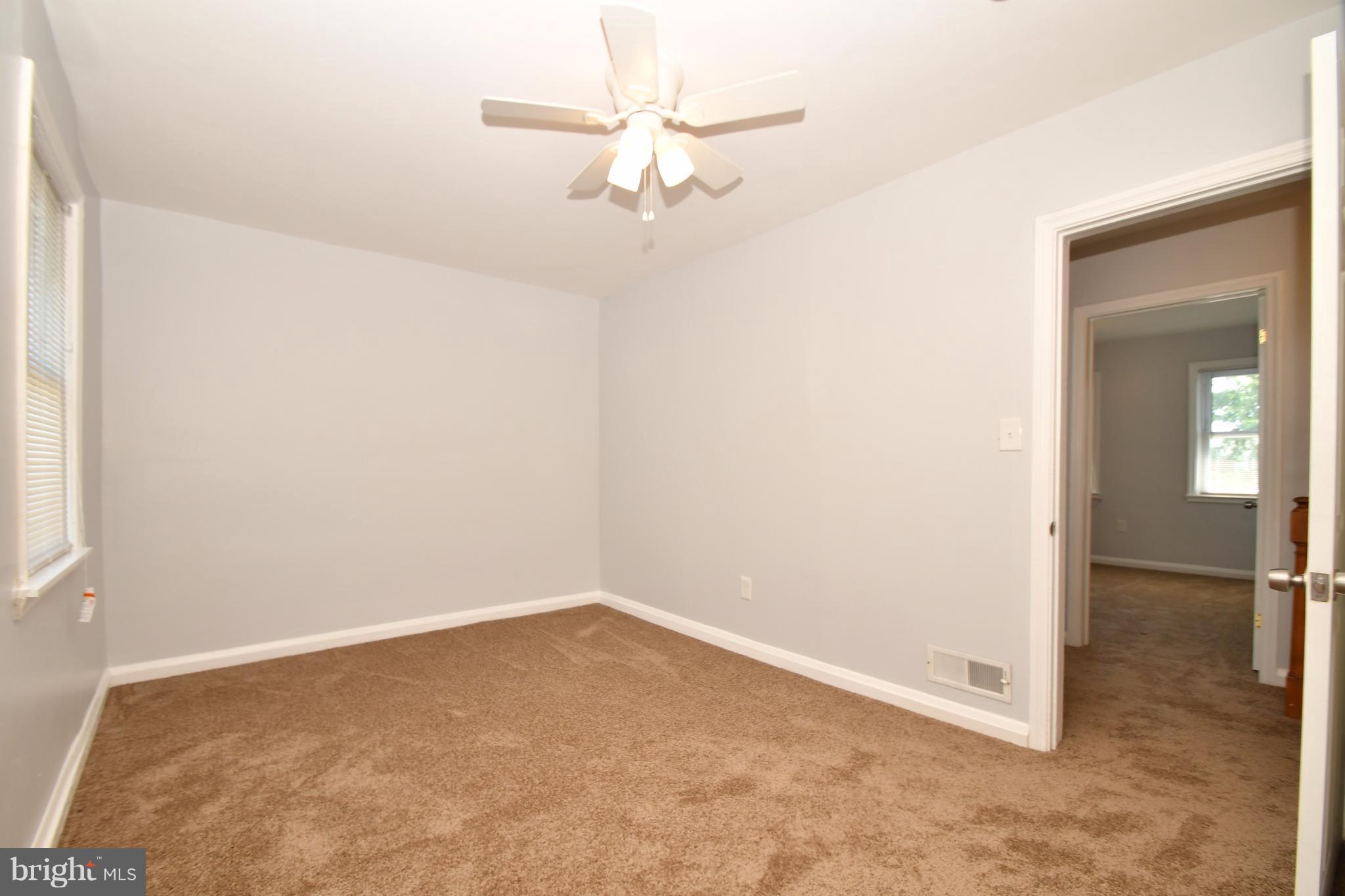 3520 Dunhaven Road Baltimore, MD 21222 - Photo 23 of 30 an empty room with a ceiling fan and a window