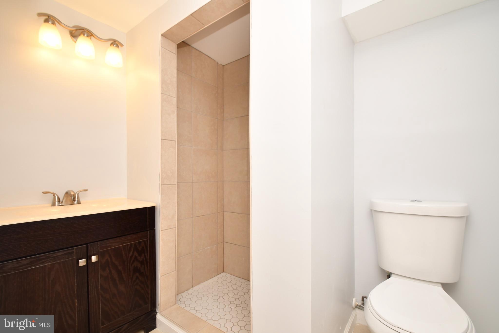 3520 Dunhaven Road Baltimore, MD 21222 - Photo 24 of 30 a bathroom with a toilet a sink and mirror