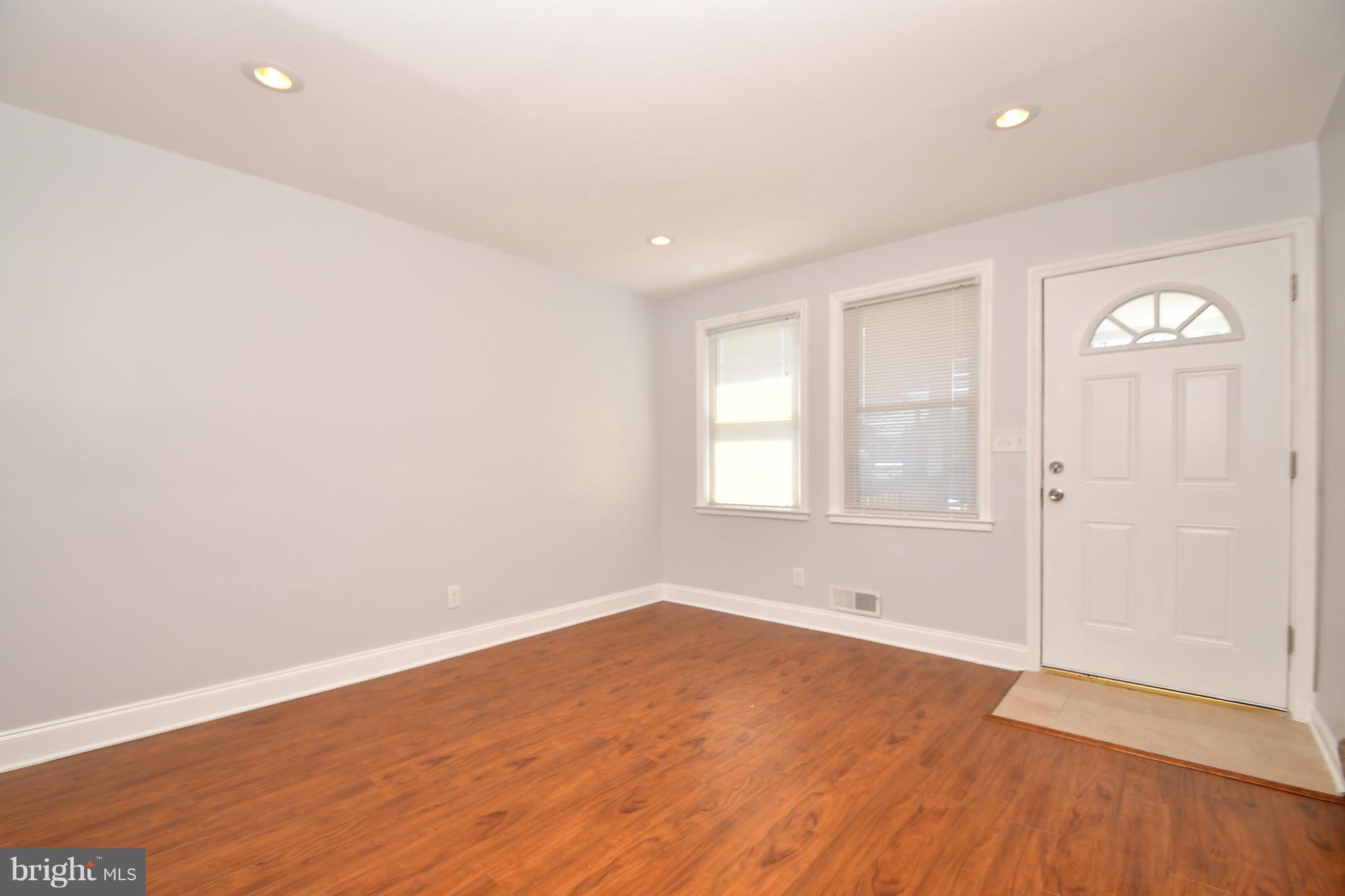 3520 Dunhaven Road Baltimore, MD 21222 - Photo 4 of 30 wooden floor in an empty room with a window