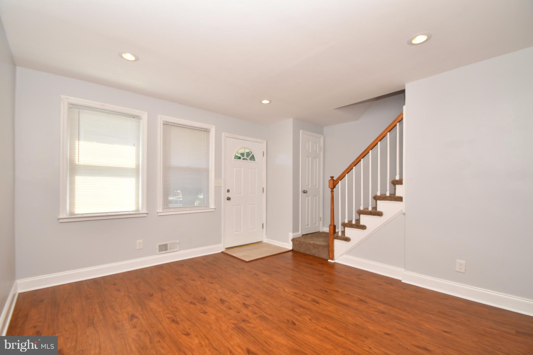 3520 Dunhaven Road Baltimore, MD 21222 - Photo 6 of 30 a view of an empty room with wooden floor and a window