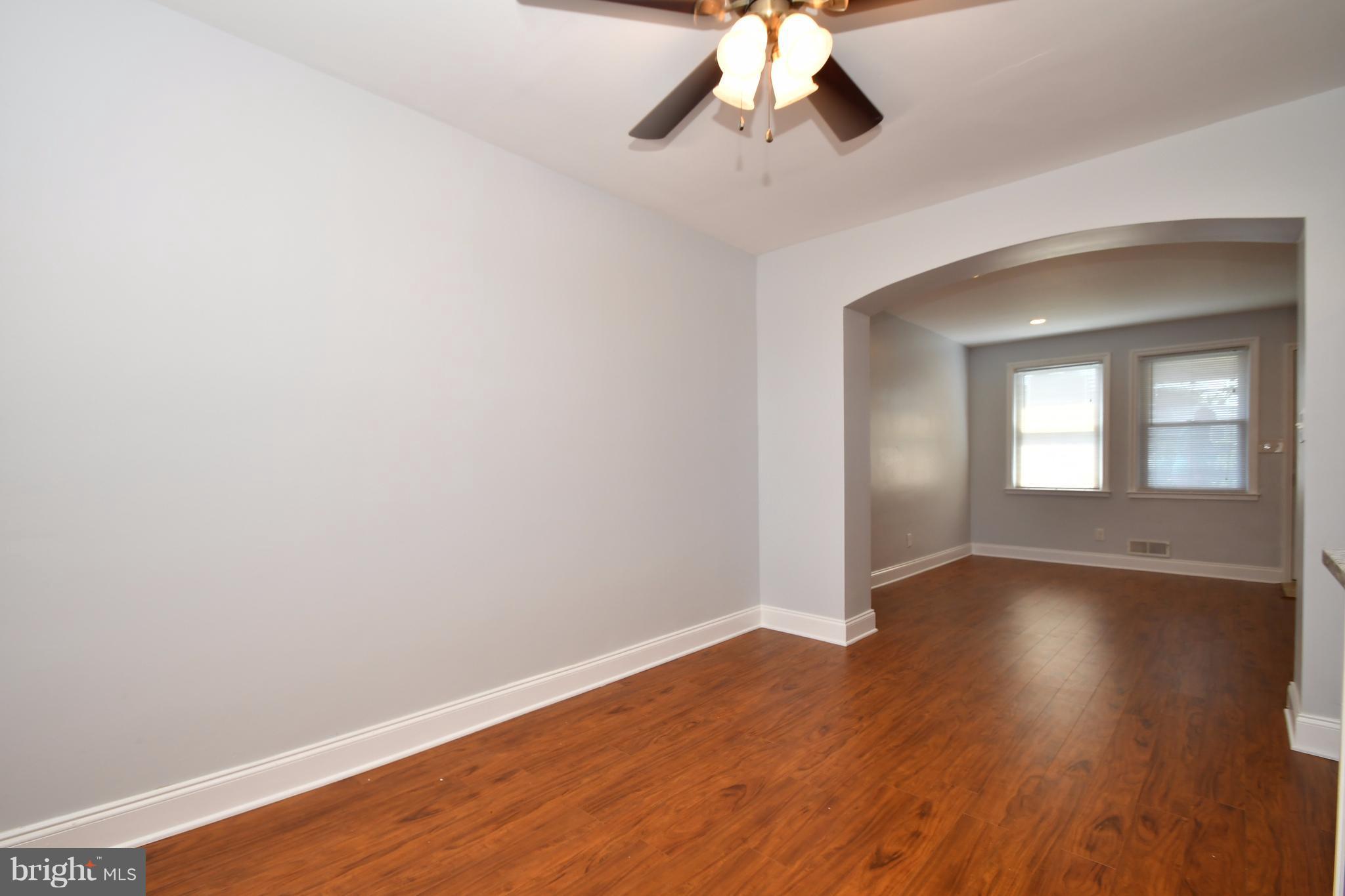 3520 Dunhaven Road Baltimore, MD 21222 - Photo 7 of 30 a view of an empty room with wooden floor and a chandelier fan