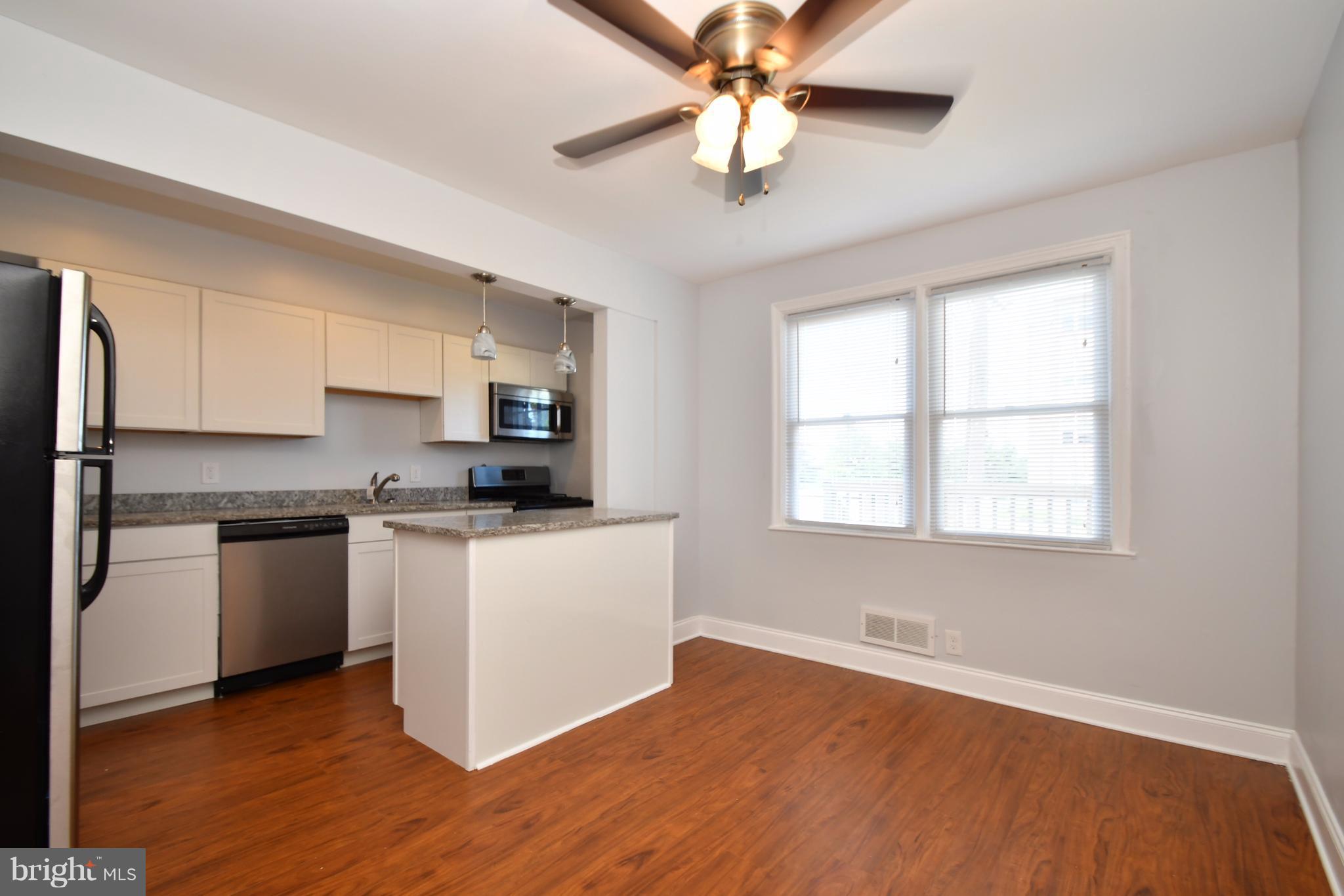 3520 Dunhaven Road Baltimore, MD 21222 - Photo 8 of 30 a kitchen with stainless steel appliances a sink cabinets and wooden floor