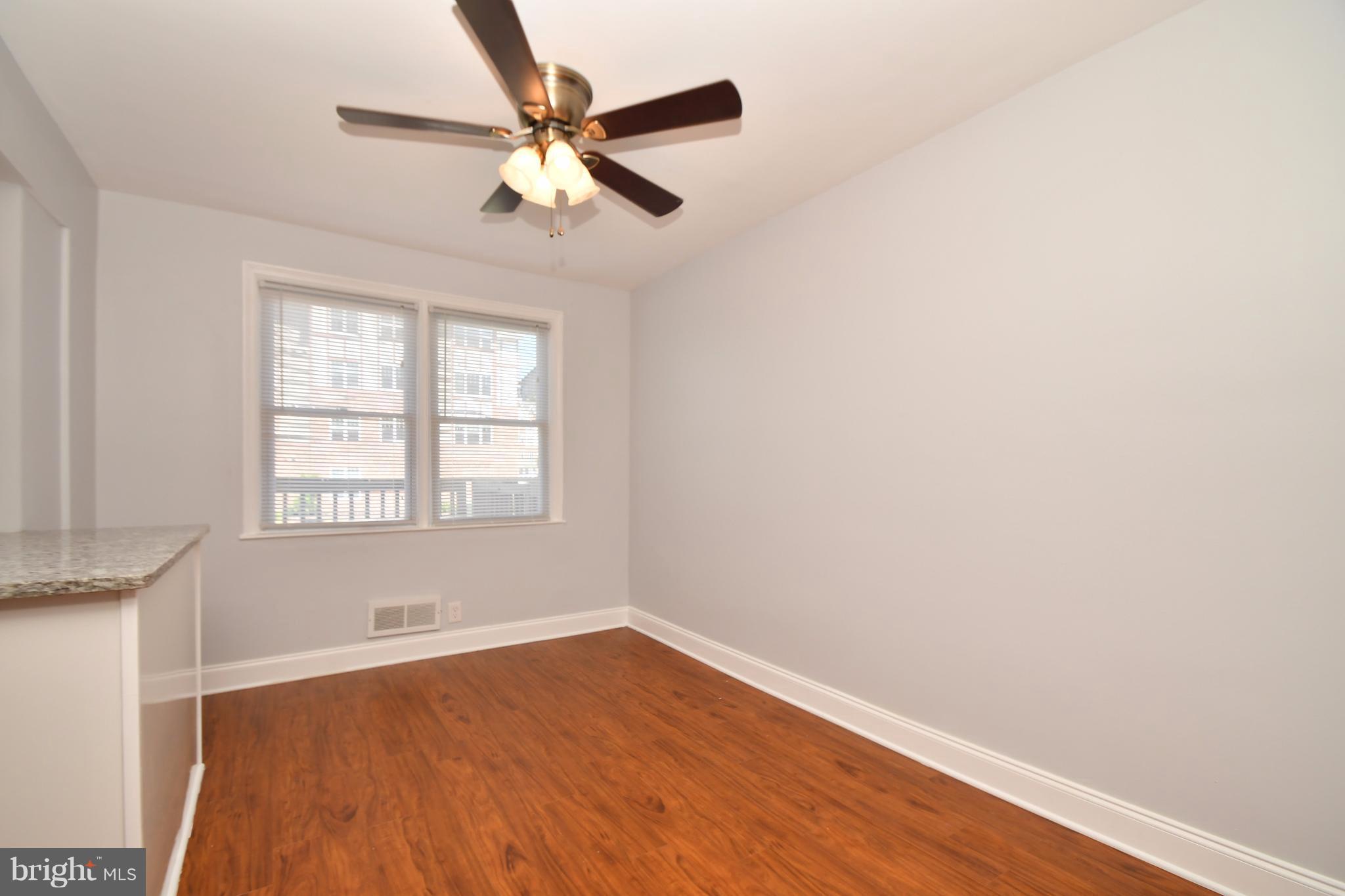 3520 Dunhaven Road Baltimore, MD 21222 - Photo 9 of 30 an empty room with wooden floor fan and windows