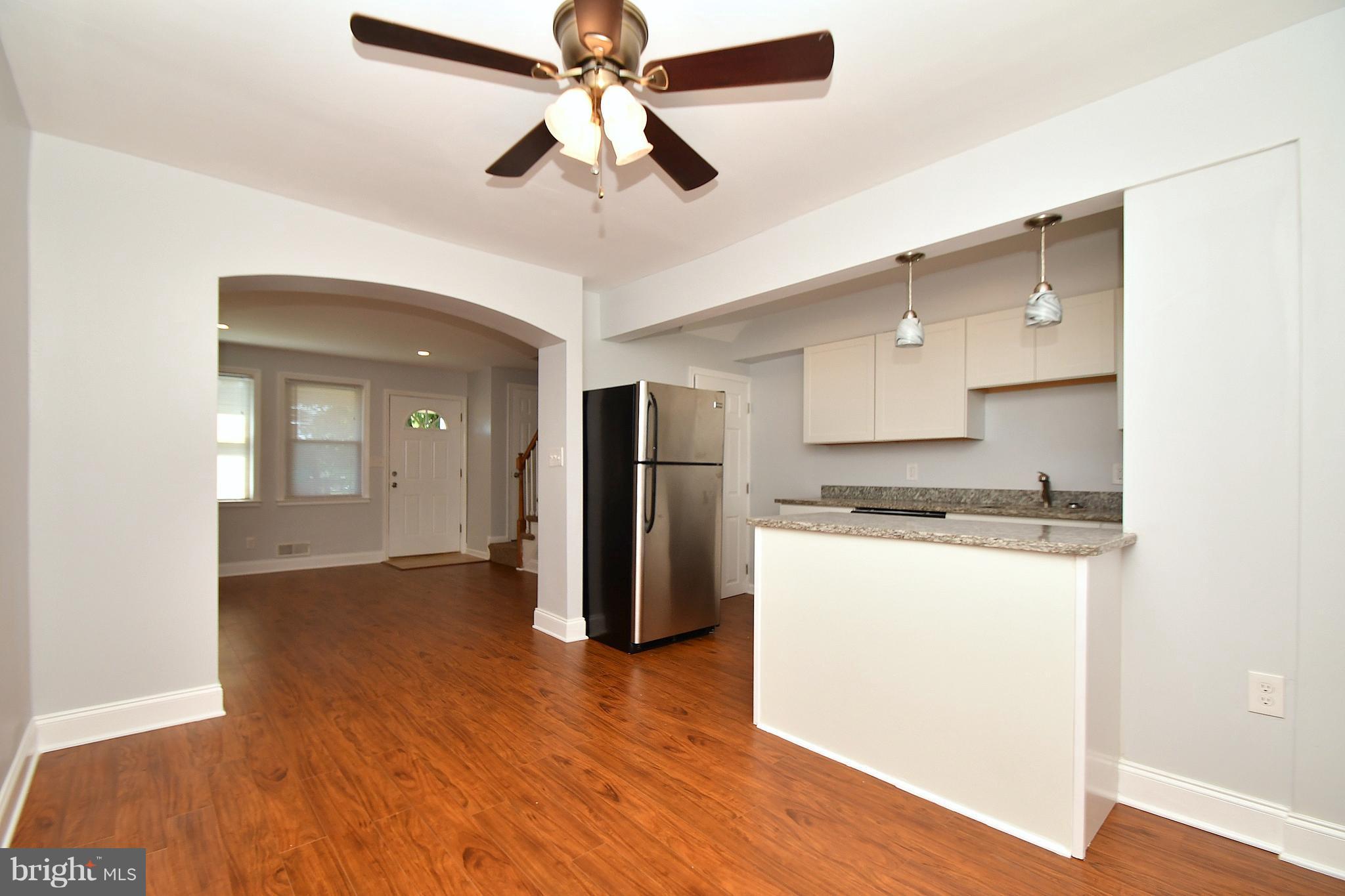 3520 Dunhaven Road Baltimore, MD 21222 - Photo 10 of 30 a kitchen with stainless steel appliances granite countertop a refrigerator a stove and a wooden floors
