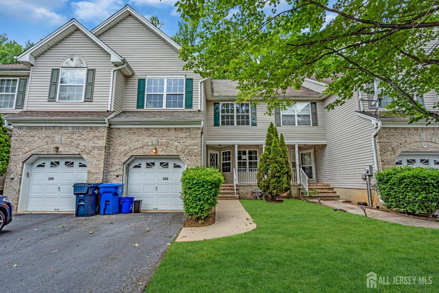 a front view of a house with a garden and plants