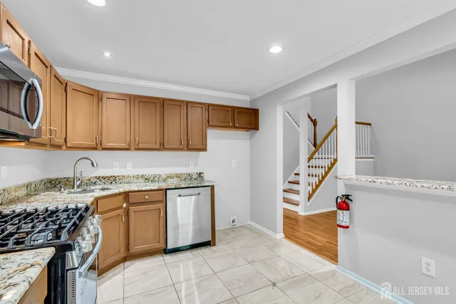 a kitchen with a sink stove and cabinets