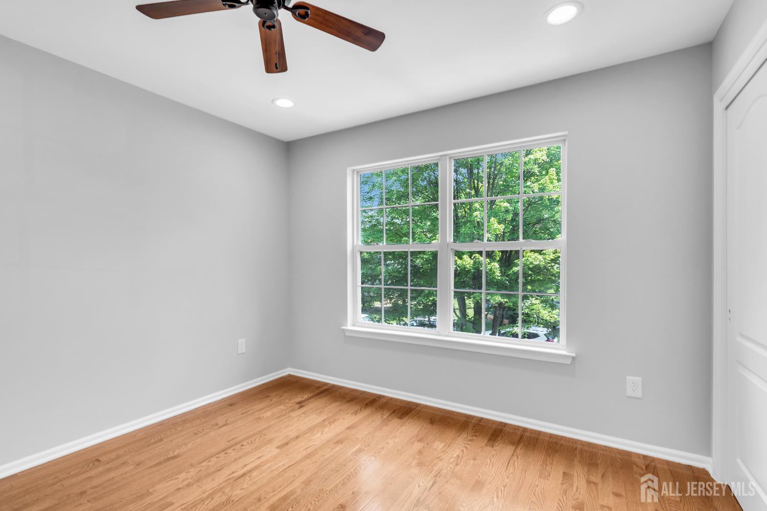 242 Hawthorne Road North Brunswick, NJ 08902 - Photo 21 of 34 a view of an empty room with wooden floor and a window