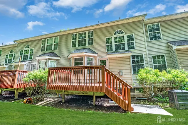 a view of a house with a yard and deck