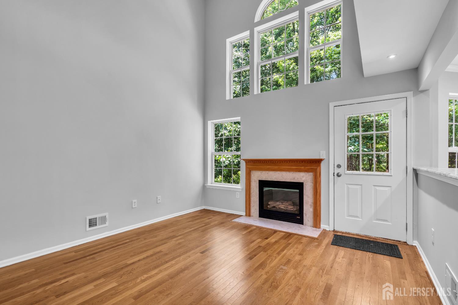 242 Hawthorne Road North Brunswick, NJ 08902 - Photo 29 of 34 an empty room with wooden floor fireplace and windows