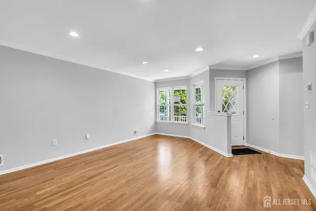 a view of wooden floor and windows in a room