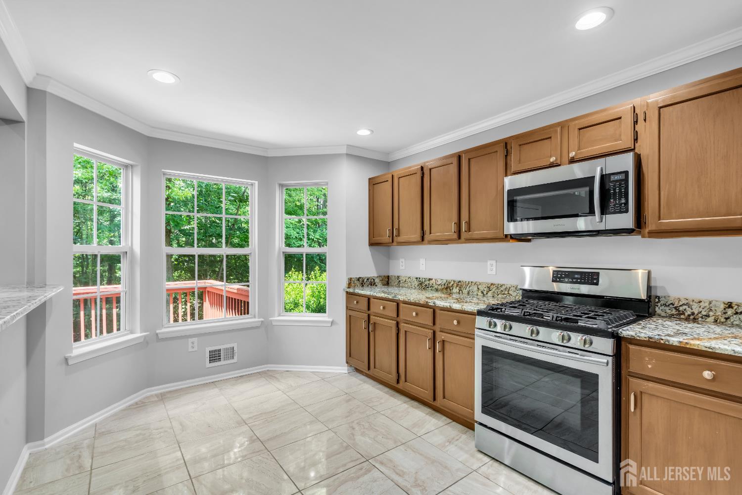 242 Hawthorne Road North Brunswick, NJ 08902 - Photo 10 of 34 a kitchen with stainless steel appliances granite countertop a stove top oven a sink and a granite counter top