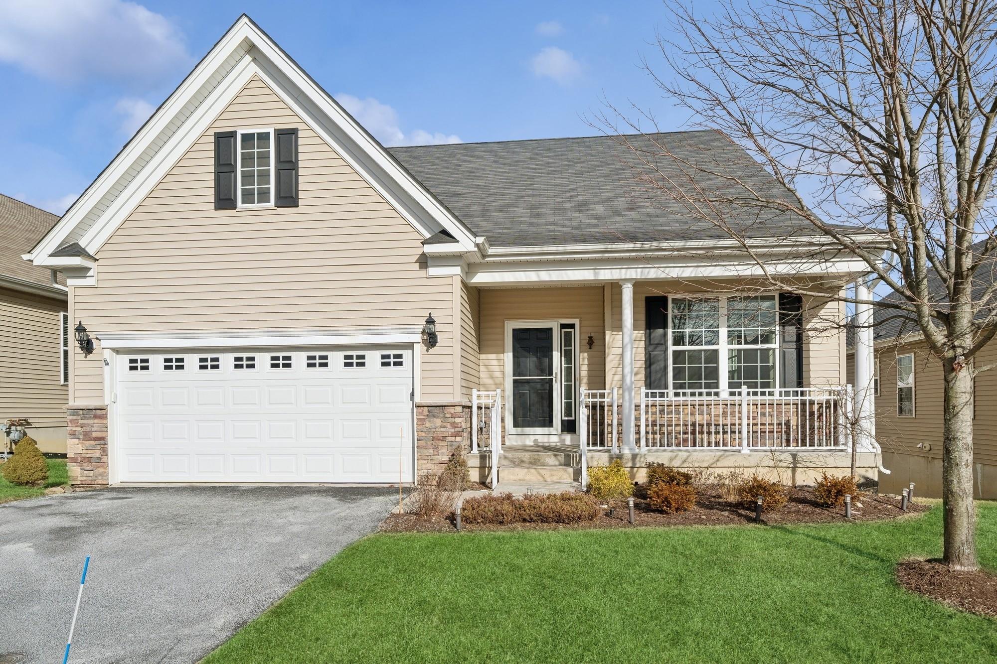 a front view of a house with a garden and yard