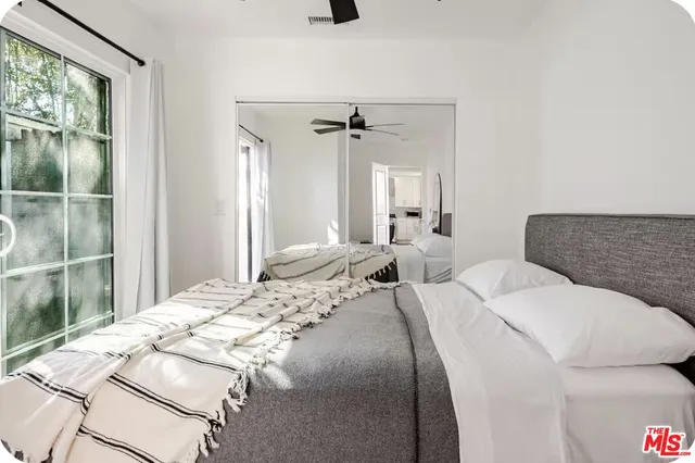 a bedroom with a bed and a chandelier