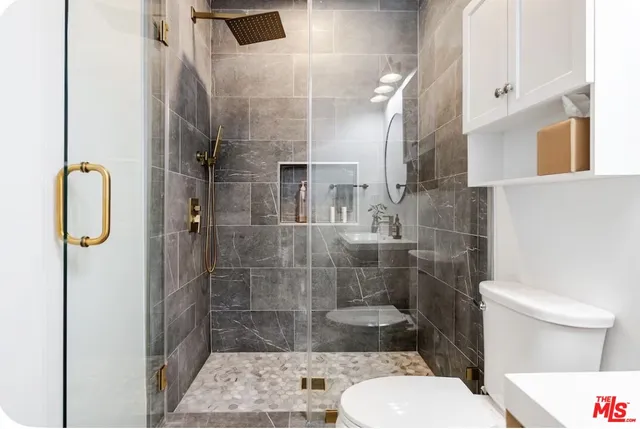 a bathroom with a toilet and a shower
