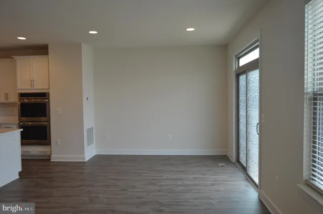 a view of room with window and wooden floor