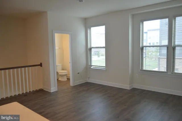 an empty room with wooden floor and closet