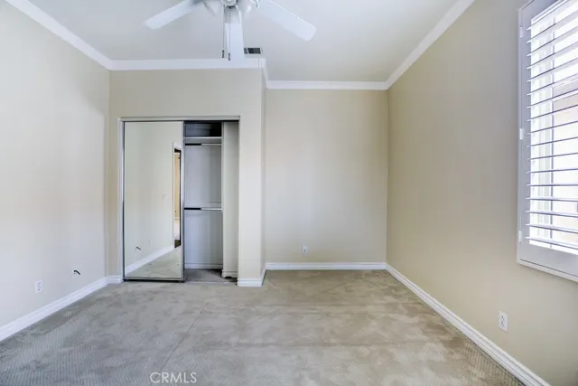 a view of a hallway with a chandelier fan and wooden floor