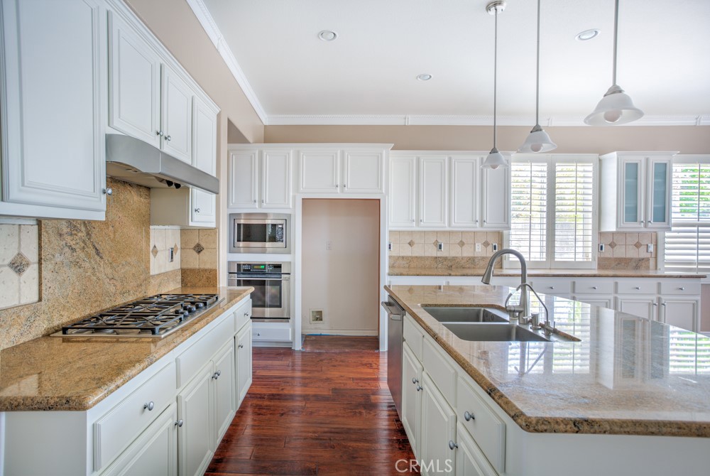 3782 Carson Way Yorba Linda, CA 92886 - Photo 22 of 48 a kitchen with stainless steel appliances granite countertop a sink stove cabinets and refrigerator