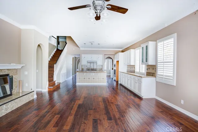 a view of front door with hallway and wooden floor