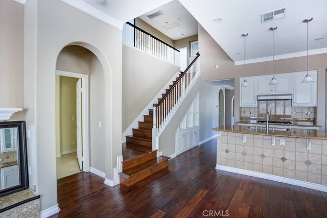 a view of a hallway with a chandelier and a ceiling fan