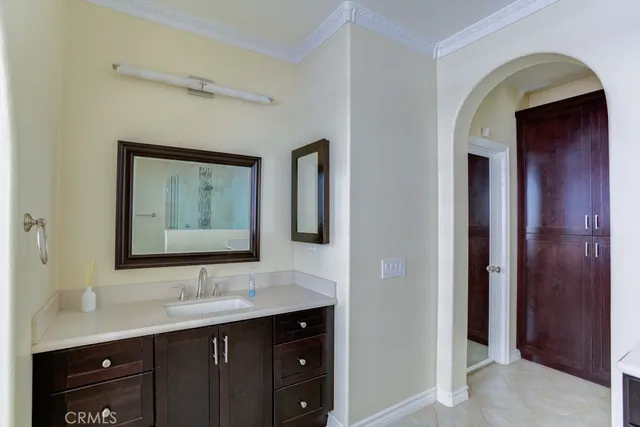 a spacious bathroom with a tub sink and mirror