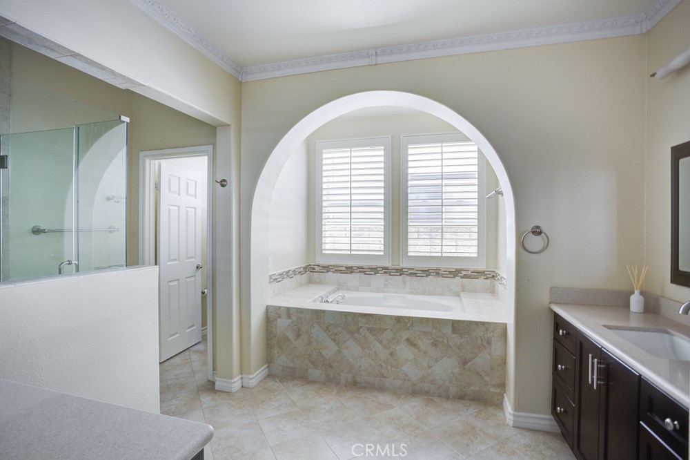 3782 Carson Way Yorba Linda, CA 92886 - Photo 30 of 48 a spacious bathroom with a tub sink and mirror