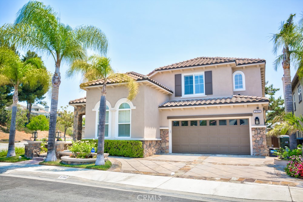 3782 Carson Way Yorba Linda, CA 92886 - Photo 3 of 48 a front view of a house with a garden and palm trees