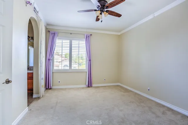 an empty room with closet and windows