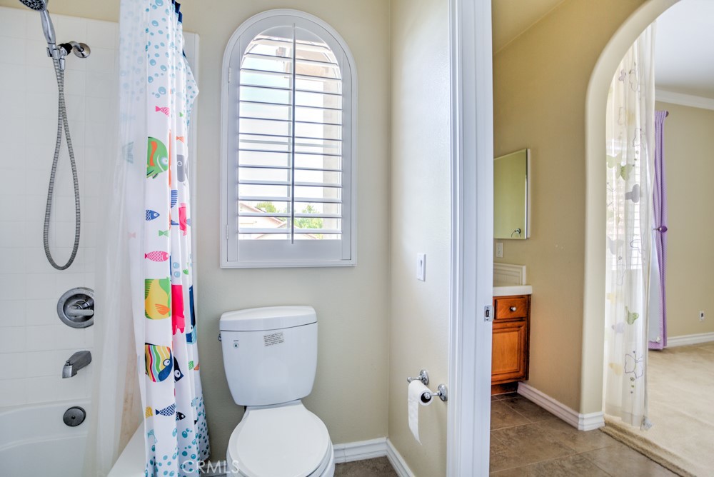 3782 Carson Way Yorba Linda, CA 92886 - Photo 35 of 48 a bathroom with a toilet and a shower curtain