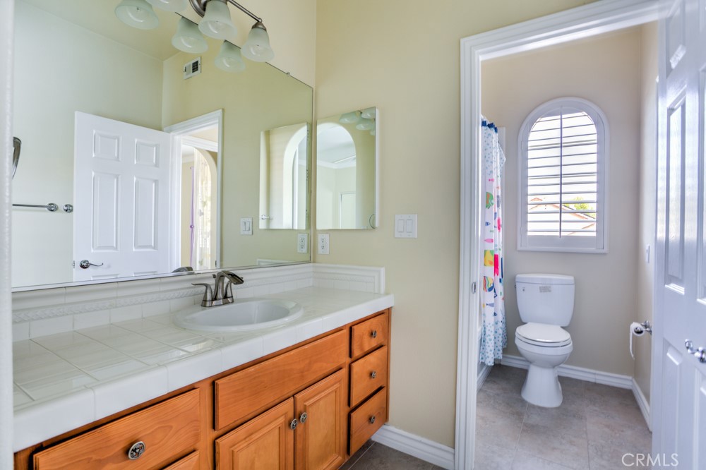 3782 Carson Way Yorba Linda, CA 92886 - Photo 36 of 48 a bathroom with a sink a toilet and a mirror