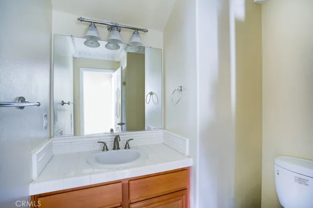 a view of a chair and table in backyard of the house