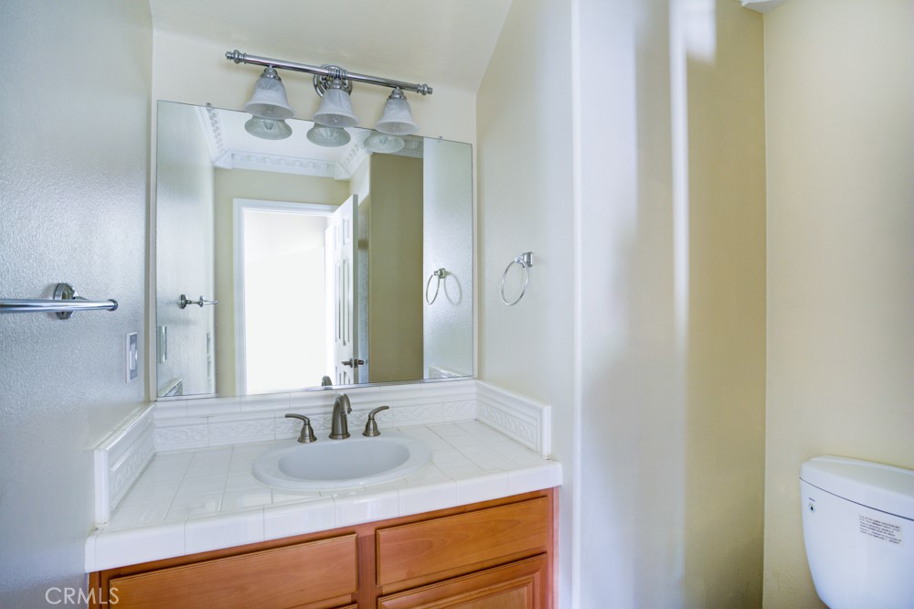 3782 Carson Way Yorba Linda, CA 92886 - Photo 43 of 48 a bathroom with a granite countertop sink and a mirror