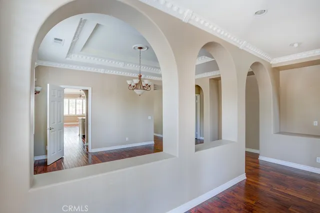 a view of a hallway with entryway wooden floor and front door
