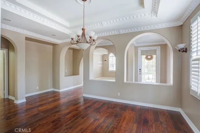 a view of a livingroom with wooden floor windows and entryway