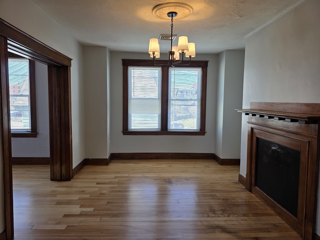 2 Hillside Street, Unit 3 Worcester, MA 01610 - Photo 15 of 23 a view of a room with wooden floor fireplace and window
