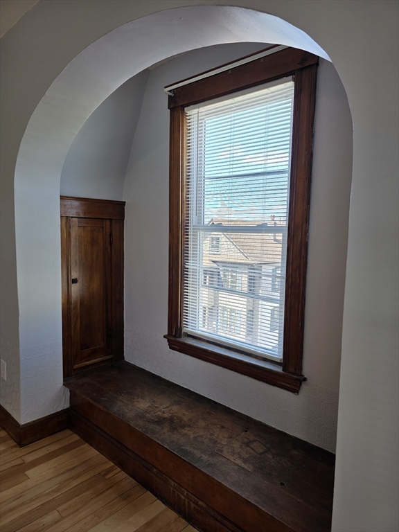 2 Hillside Street, Unit 3 Worcester, MA 01610 - Photo 18 of 23 a view of an empty room with wooden floor and a window