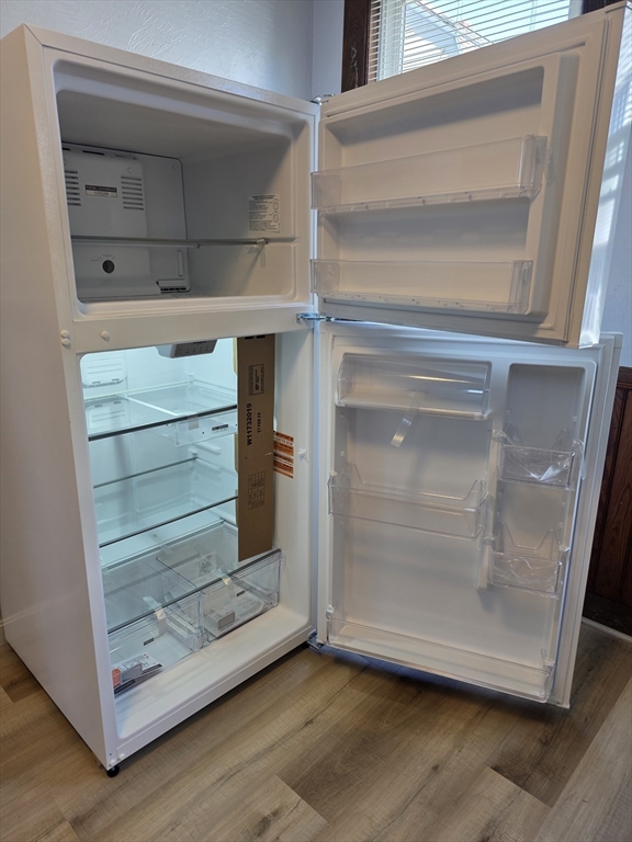 2 Hillside Street, Unit 3 Worcester, MA 01610 - Photo 10 of 23 a view of an empty room with wooden floor and a window