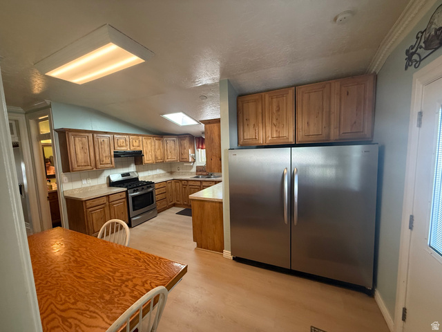 541 300 North Provo, UT 84606 - Photo 21 of 36 Spacious kitchen featuring wood-finish cabinetry, stainless steel appliances, and a gas range