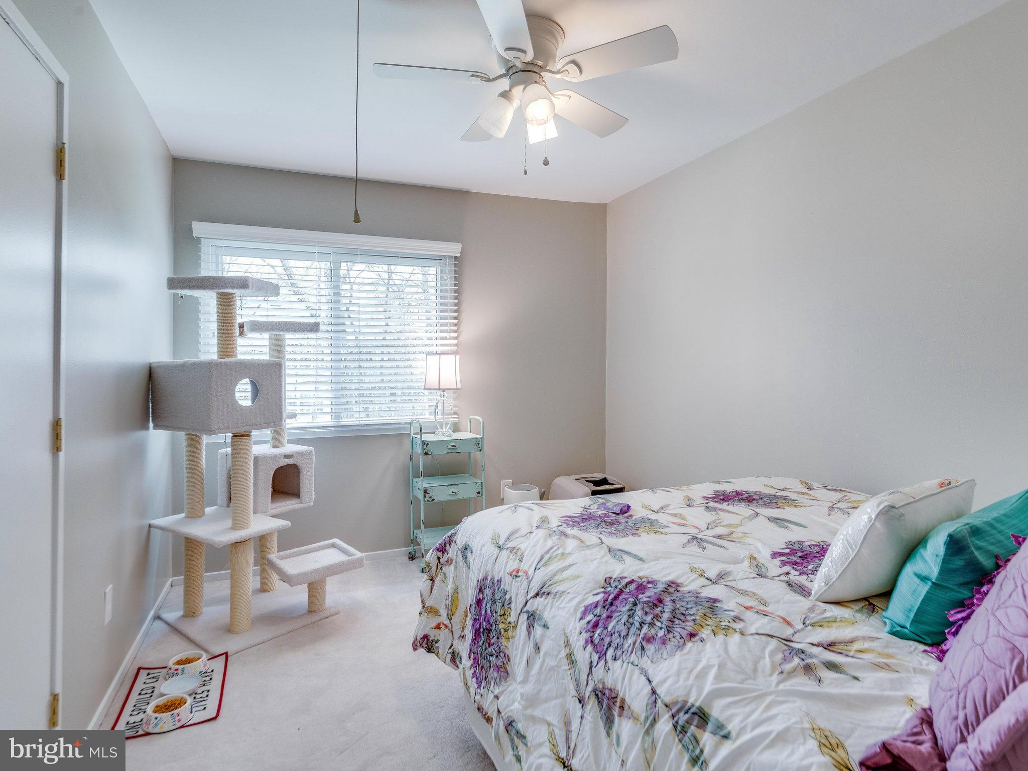 2269 Wheelwright Court Reston, VA 20191 - Photo 16 of 28 a bedroom with a bed and a chandelier